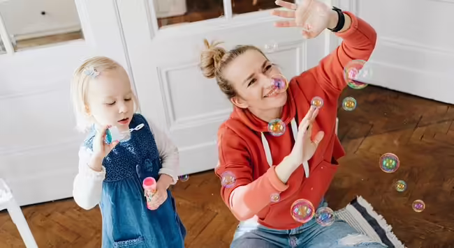 Mother and child blowing bubbles 