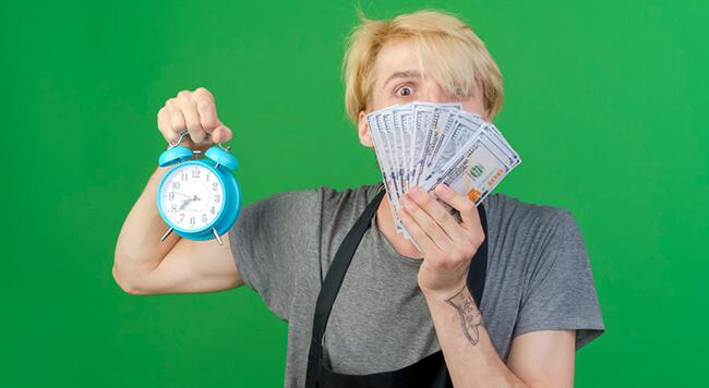 Shocked man holding clock and cash