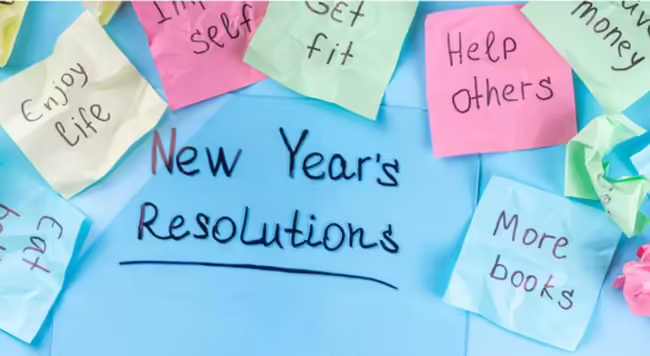 Text that says New Year's Resolutions with sticky notes that have resolutions on them.