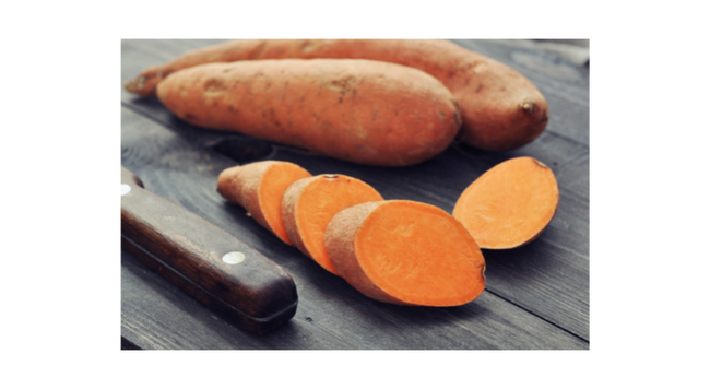 sweet potatoes on cutting board 