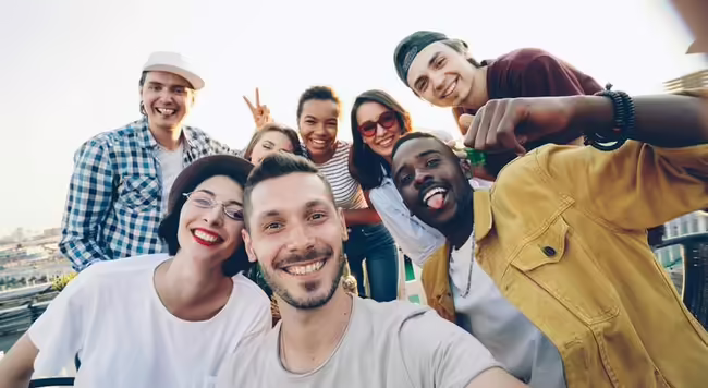Group of people smiling and posing for a picture