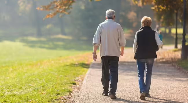 man and women walking in the park