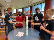 youth working on STEM Cup Stacking Challenge