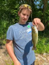 youth holding a bass fish