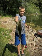 youth holding bass fish