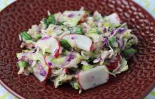 Red bowl filled with coleslaw using zucchini