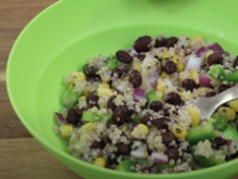 Light green bowl filled with quinoa salad