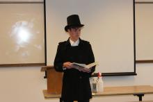 youth in a stovepipe hat performs a speech