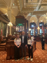 Two girls pose with a senator