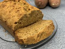 Sweet potato bread loaf with a cut slice laying down
