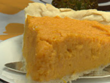 Slice of sweet potato pie on plate with yellow background
