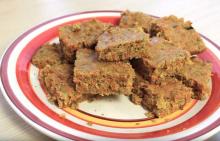 Red and white plate with stack of carrot-zucchini bars cut into squares