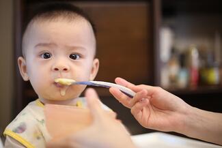 feeding baby spoonful of food