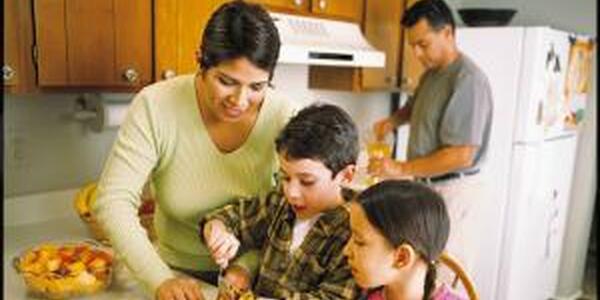 family making food together in kitchen