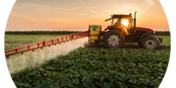 tractor spraying pesticide in field