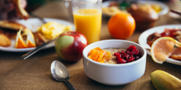 Healthy breakfast with fruits, juice, and oatmeal