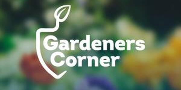 Blurry flower background with Gardeners Corner logo over it
