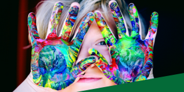 child with paint covered hands and the word inspire