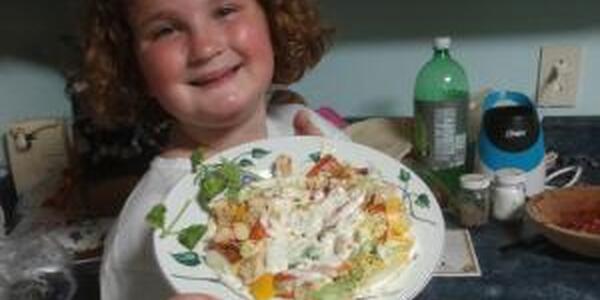 girl with plate of food she made