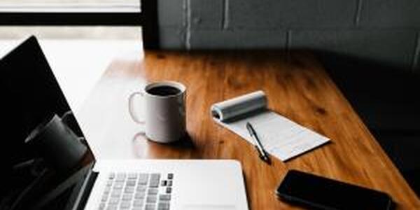 laptop coffee in cup notepad on wooden desk