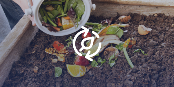 A bucket of food scraps being dumped on a compost pile.