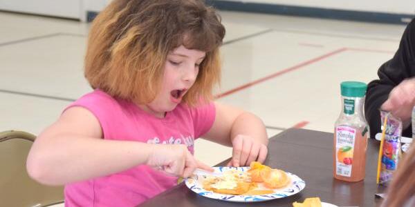 little girl eating pancakes