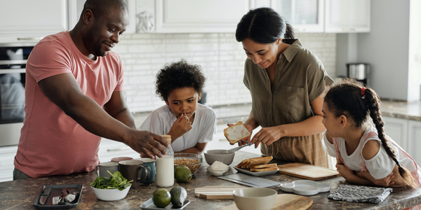 family learning how to create a healthy meal