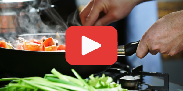 A person cooking food in a skillet with a YouTube play button graphic over the top of the image.