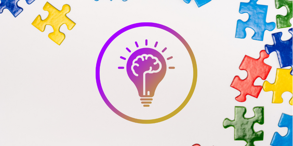 Puzzle pieces surrounding an icon of a lightbulb and a brain.