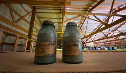 Two soil samples collected in jars sitting on a shelf inside a shed. 