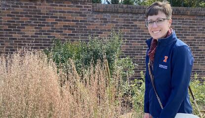 Erin Garret standing next to little bluestem in a garden