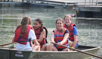 4-H campers enjoy water activities in row boat