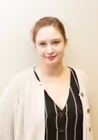 Barbara Dubravec standing against a white wall