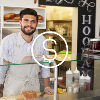 man at a counter of local small business